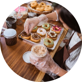 Woman decorates a donats